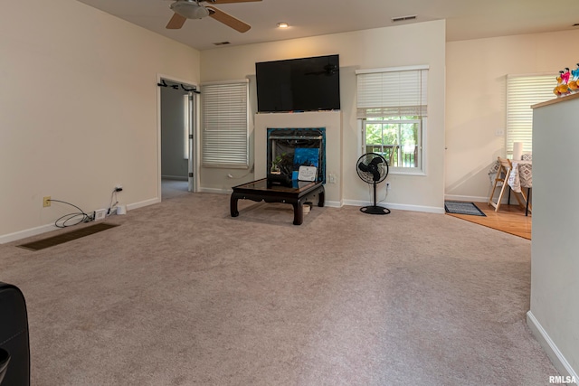 living room featuring carpet and ceiling fan