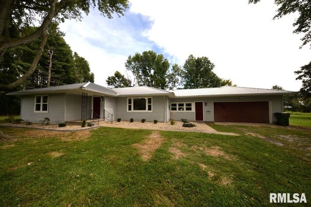 view of front of property with a garage and a front yard