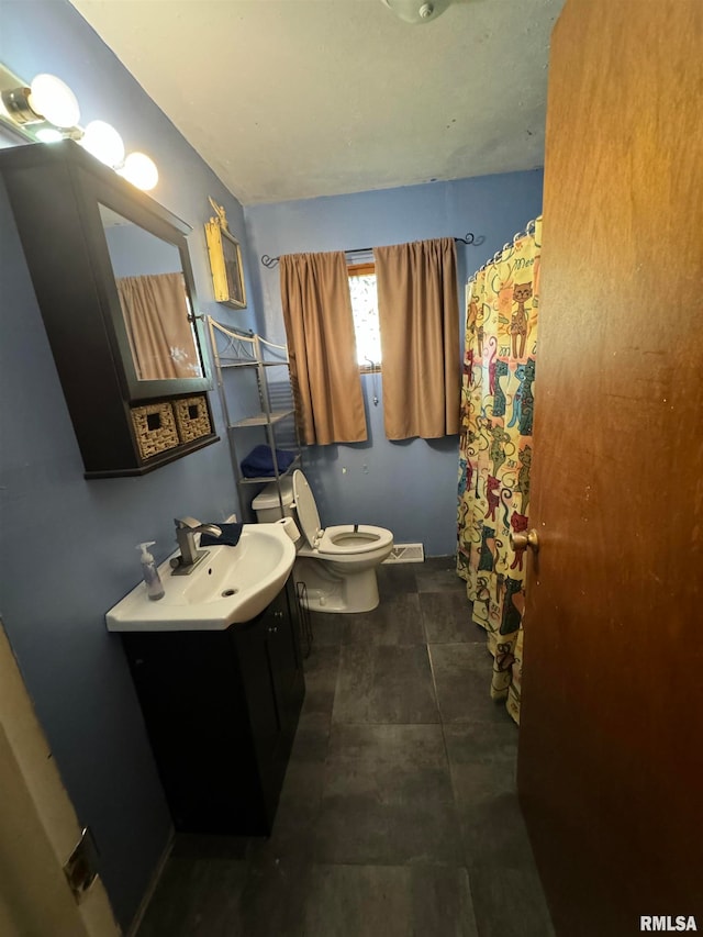 bathroom featuring tile patterned flooring, vanity, toilet, and a shower with curtain