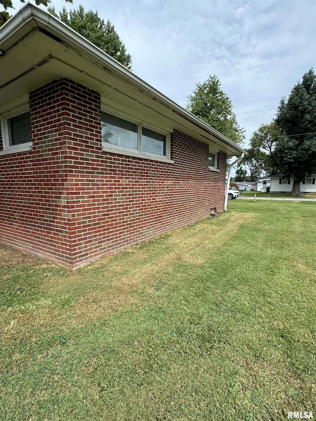 view of home's exterior with a yard