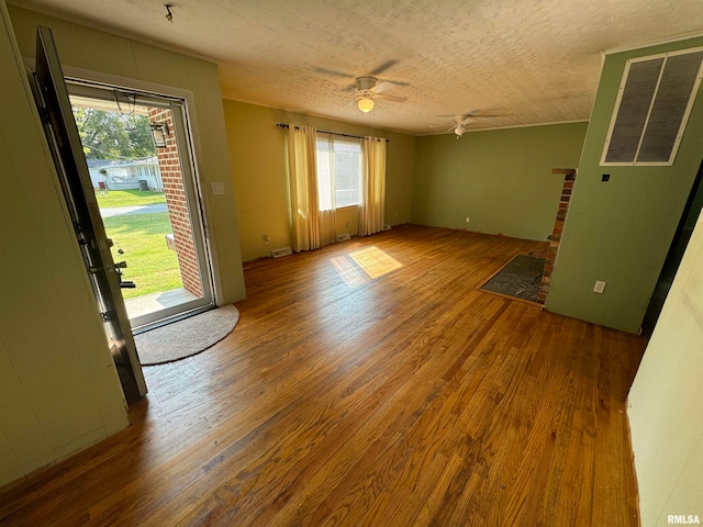 spare room featuring ceiling fan, a wealth of natural light, and hardwood / wood-style flooring