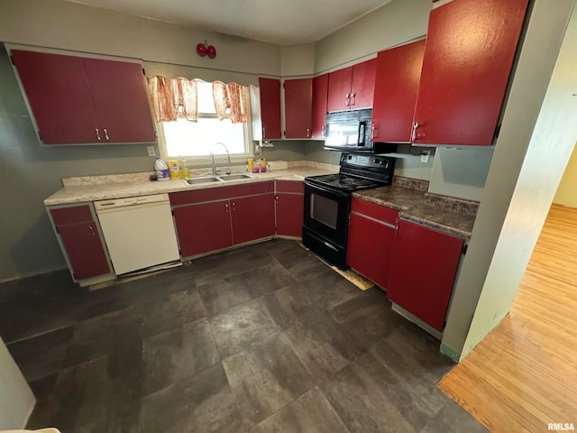 kitchen featuring black appliances, sink, and dark hardwood / wood-style floors