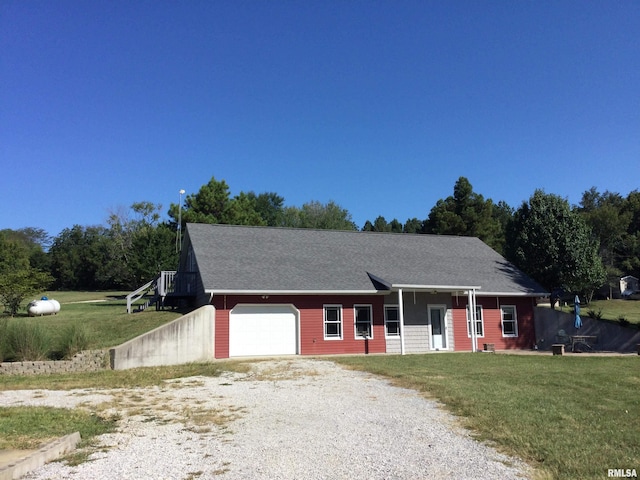 view of front of house with a garage and a front yard