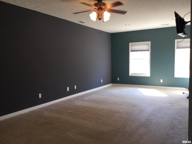 carpeted empty room featuring a textured ceiling and ceiling fan