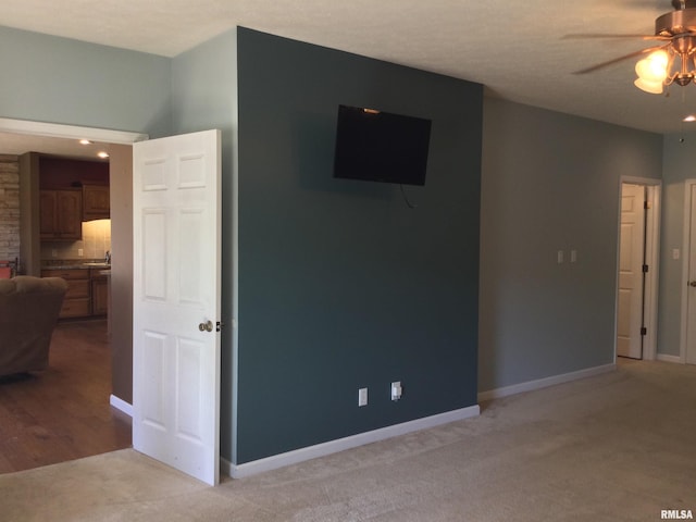 living room featuring ceiling fan and light carpet