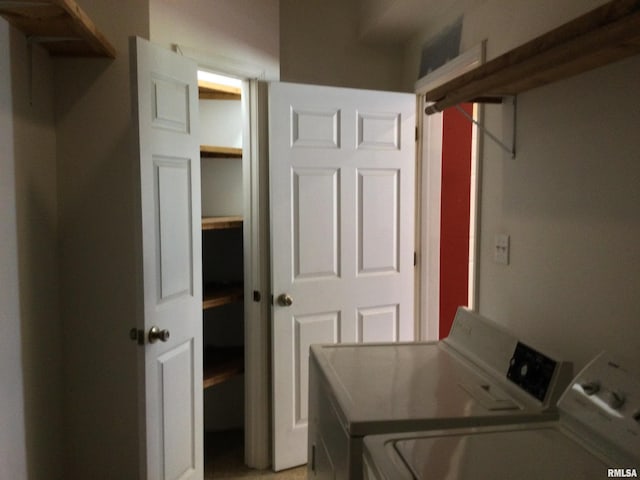 washroom with washing machine and clothes dryer