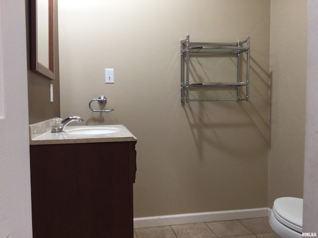 bathroom with vanity, toilet, and tile patterned flooring