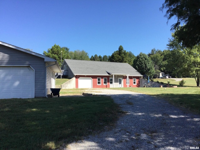 ranch-style home with a front lawn and a garage