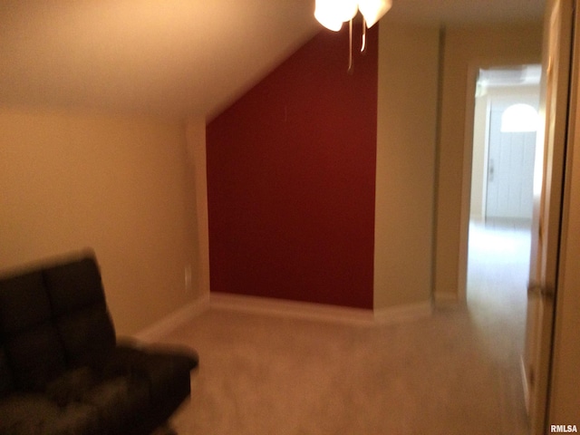 unfurnished room featuring lofted ceiling and carpet flooring