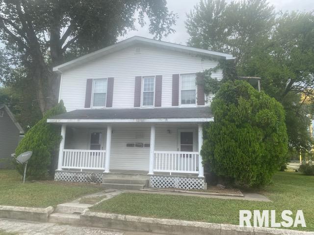 1808 Pine St, Murphysboro, IL 62966 - farmhouse with a front lawn and covered porch
