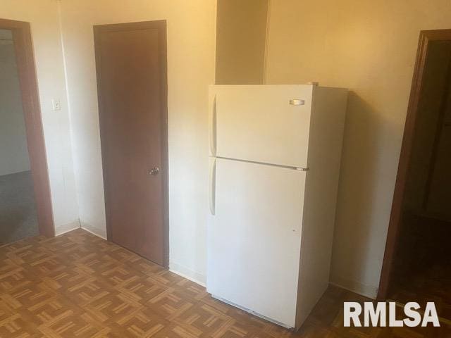 kitchen featuring white refrigerator and parquet floors