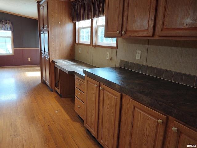 kitchen featuring crown molding, plenty of natural light, and light wood-type flooring