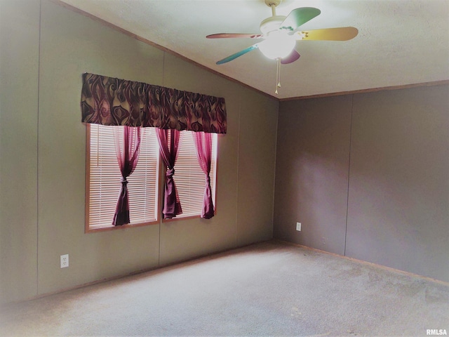 unfurnished room featuring lofted ceiling, ceiling fan, crown molding, and carpet floors