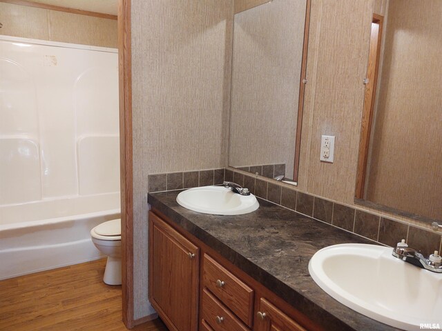 bathroom with vanity, toilet, hardwood / wood-style floors, and backsplash