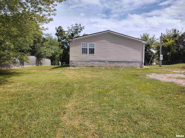 view of side of property featuring a yard