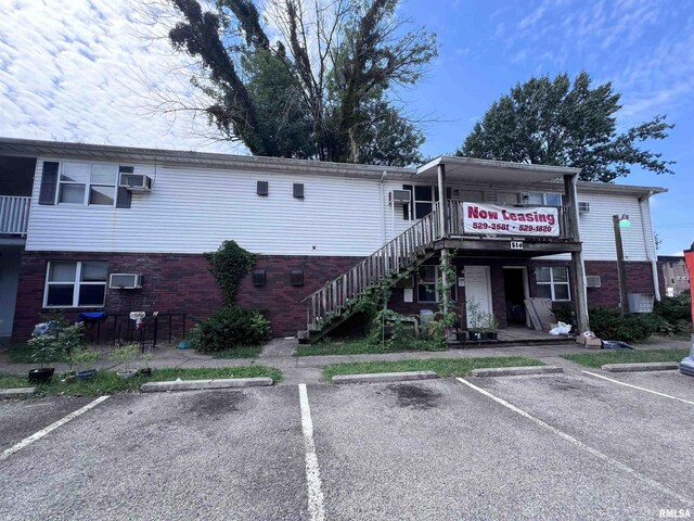 view of property featuring uncovered parking