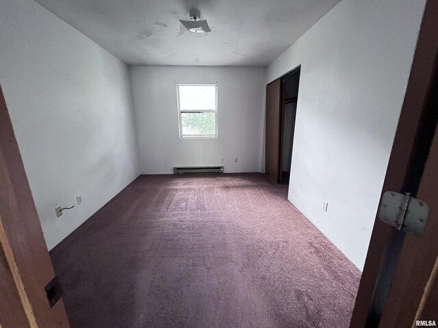 unfurnished bedroom with a baseboard radiator and carpet floors