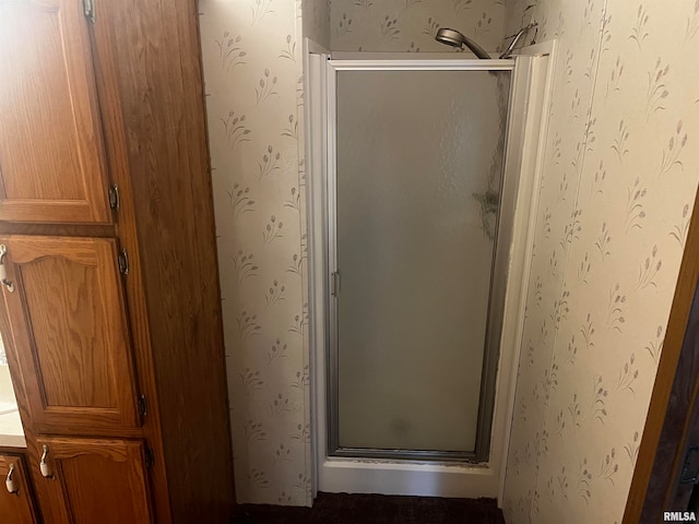 bathroom with a shower with door