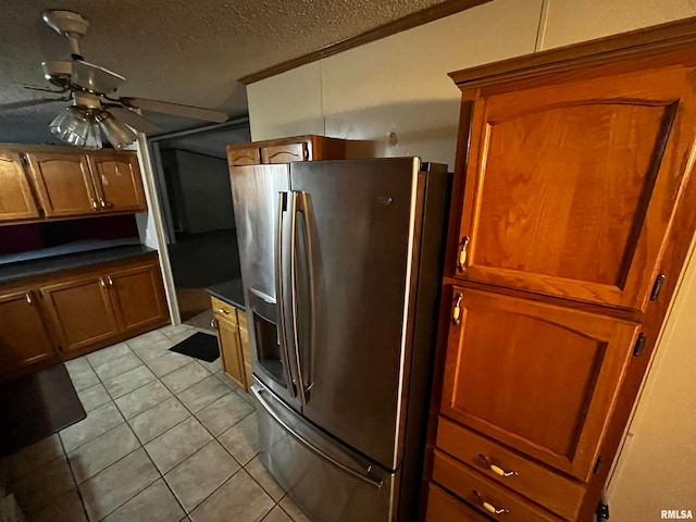 kitchen featuring light tile patterned flooring, ceiling fan, a textured ceiling, and stainless steel refrigerator with ice dispenser