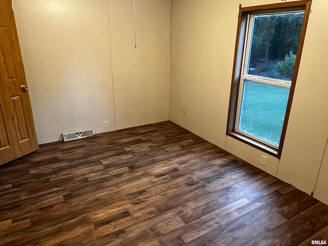 empty room with dark hardwood / wood-style floors