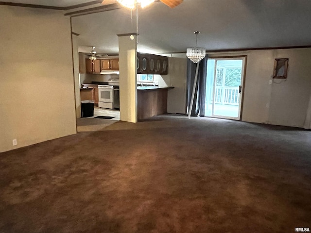 unfurnished living room featuring ceiling fan with notable chandelier, light colored carpet, and crown molding