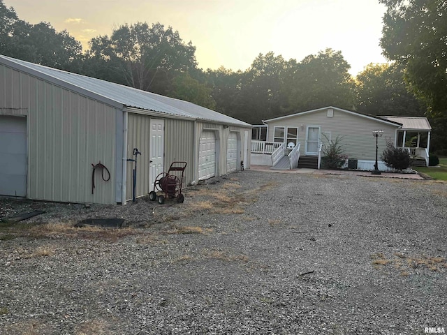 exterior space with an outbuilding and a garage