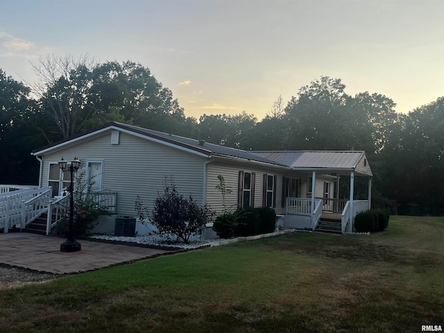 view of front of property featuring a yard and a patio