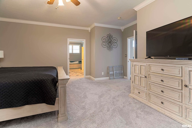 carpeted bedroom with ornamental molding, ensuite bath, and ceiling fan