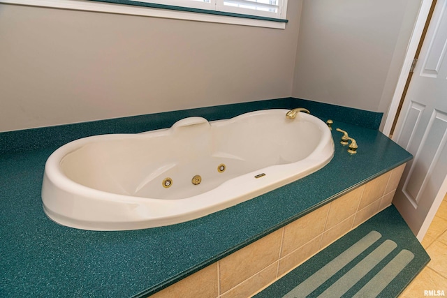 bathroom featuring a relaxing tiled tub and tile patterned flooring