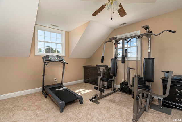 workout area with lofted ceiling, ceiling fan, and light colored carpet