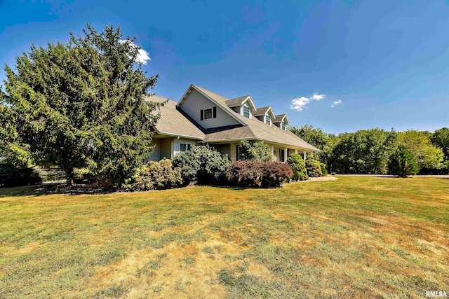 view of side of home featuring a yard