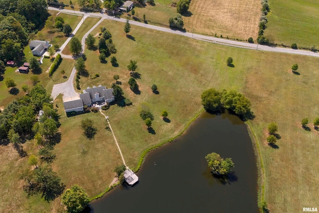 birds eye view of property with a water view and a rural view