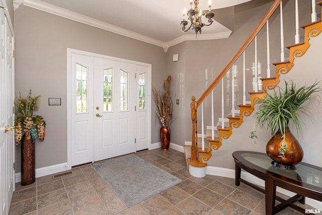 foyer entrance with a notable chandelier and ornamental molding