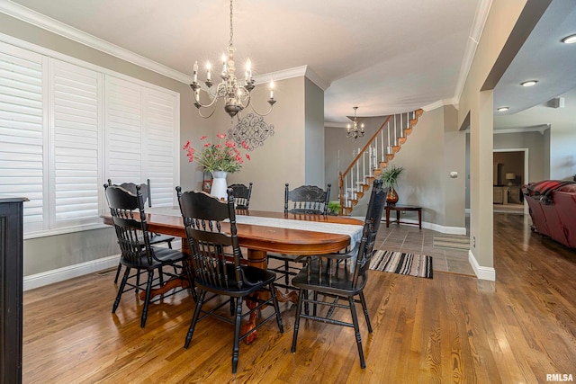 dining room featuring crown molding, hardwood / wood-style flooring, and a chandelier