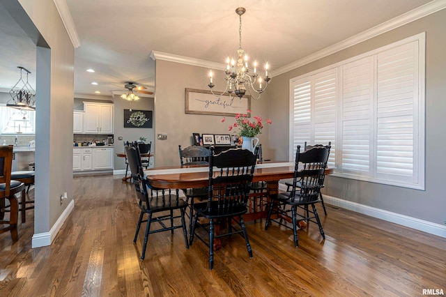 dining area with dark wood-type flooring, ceiling fan with notable chandelier, and crown molding