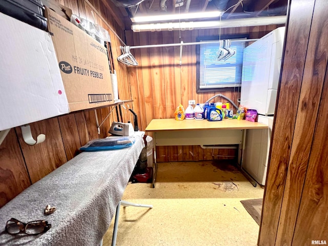 bedroom with washer / clothes dryer and wood walls