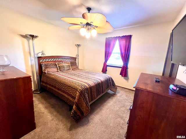 bedroom with ceiling fan and carpet floors