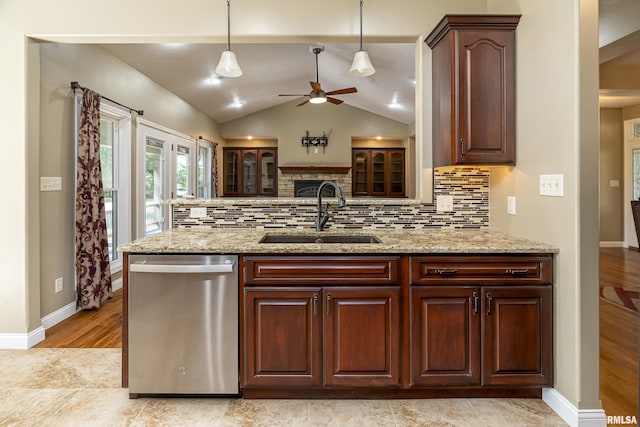 kitchen featuring a sink, backsplash, vaulted ceiling, and dishwasher