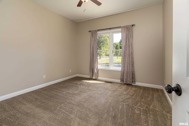 spare room with a ceiling fan, visible vents, baseboards, and carpet flooring