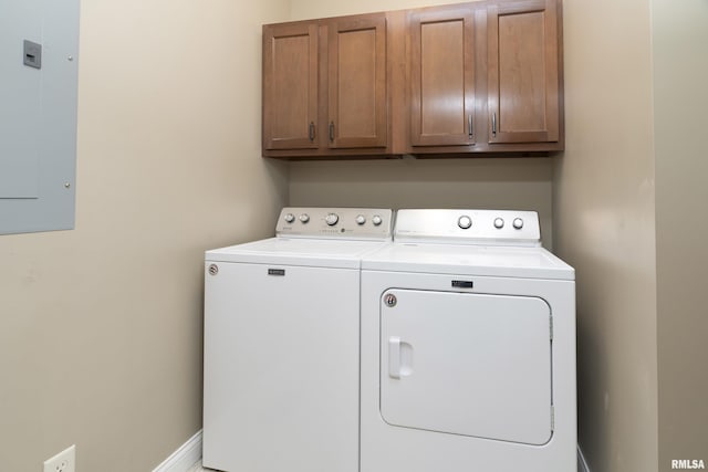 clothes washing area with washer and dryer, electric panel, cabinet space, and baseboards