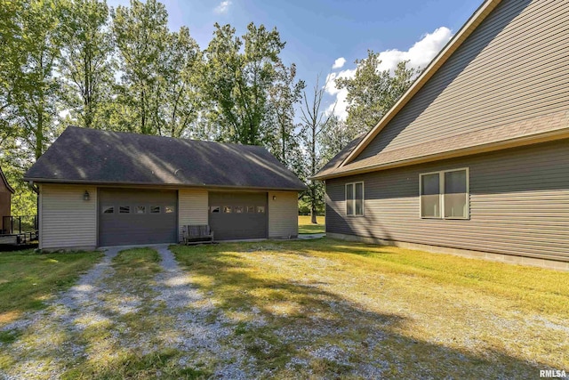 exterior space featuring a detached garage and an outbuilding