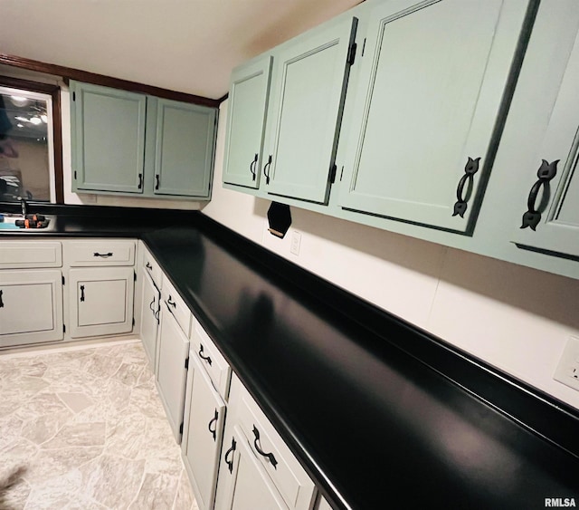 kitchen featuring green cabinetry and sink