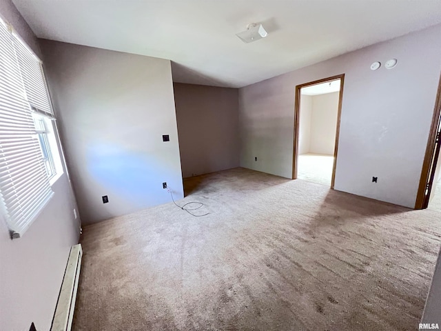 spare room with baseboard heating and carpet floors