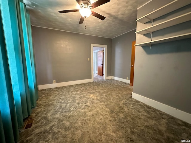 carpeted empty room featuring a textured ceiling and ceiling fan