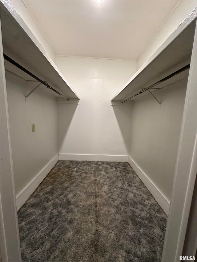 spacious closet featuring dark carpet