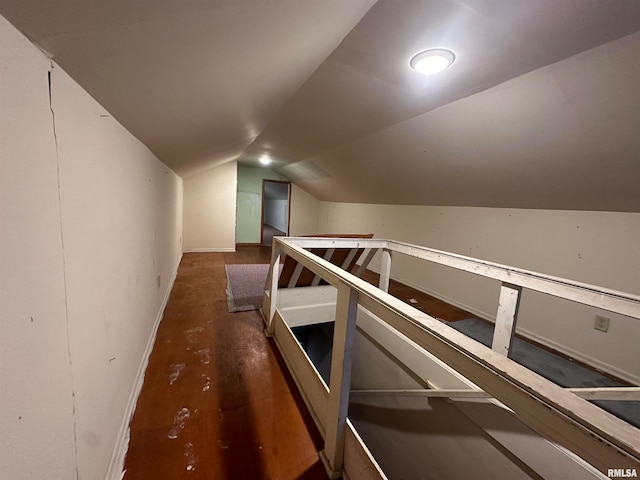 hall featuring dark hardwood / wood-style flooring and vaulted ceiling