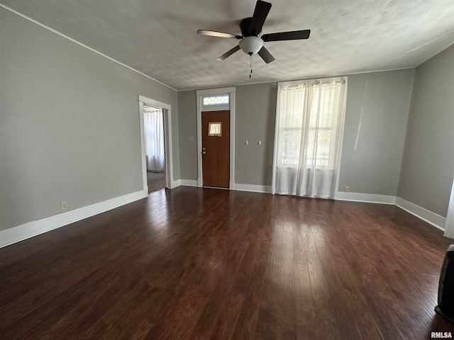 entryway with dark hardwood / wood-style floors, ceiling fan, and a textured ceiling