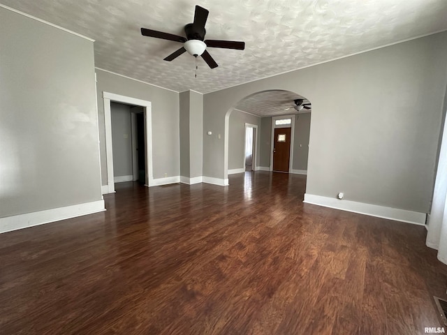 unfurnished room with a textured ceiling, ceiling fan, and dark hardwood / wood-style floors