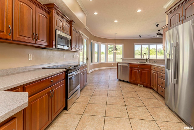 kitchen featuring sink, hanging light fixtures, stainless steel appliances, light tile patterned floors, and ceiling fan