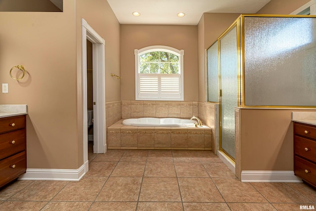 full bathroom with shower with separate bathtub, tile patterned flooring, vanity, and toilet